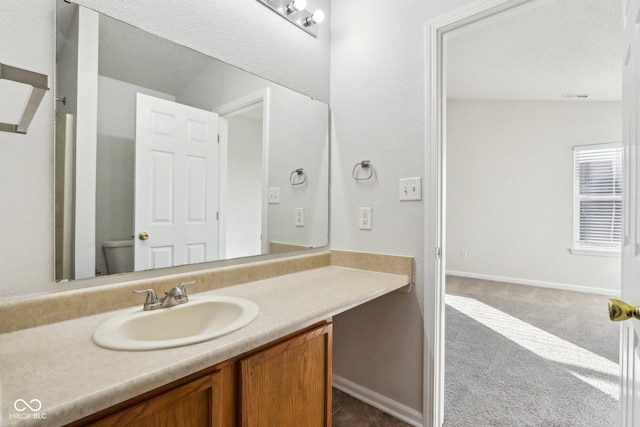 bathroom with vanity and toilet