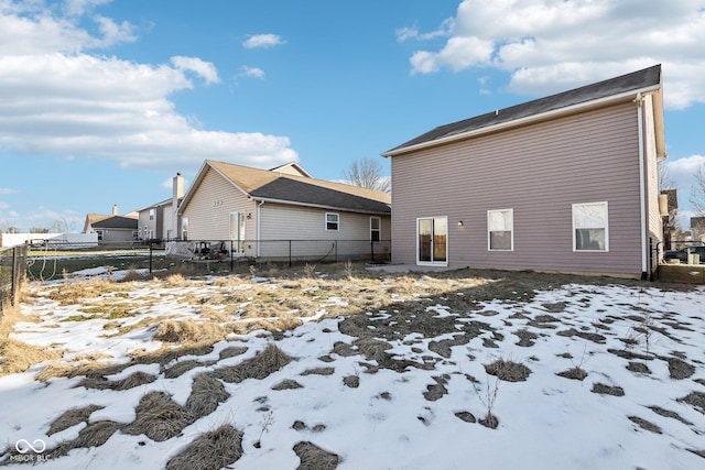 view of snow covered rear of property