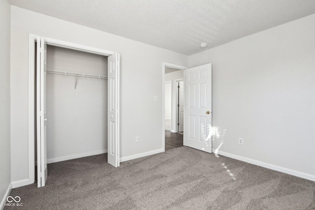 unfurnished bedroom with a closet, carpet, and a textured ceiling