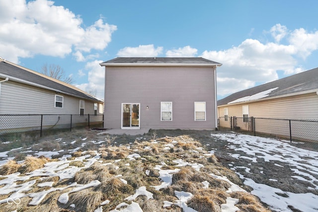 view of snow covered rear of property