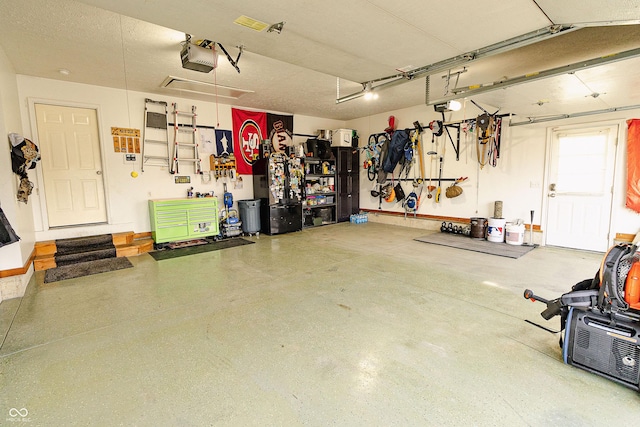 garage featuring a garage door opener and a workshop area