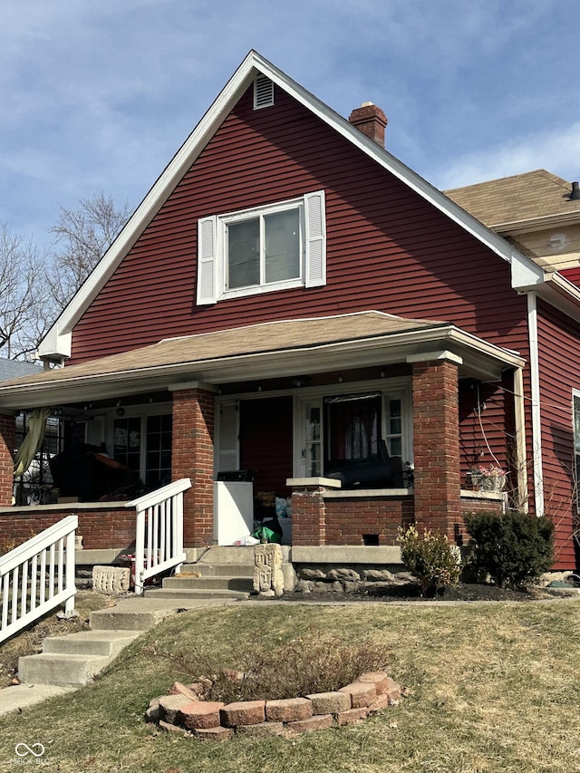 view of front of home featuring a porch and a front yard