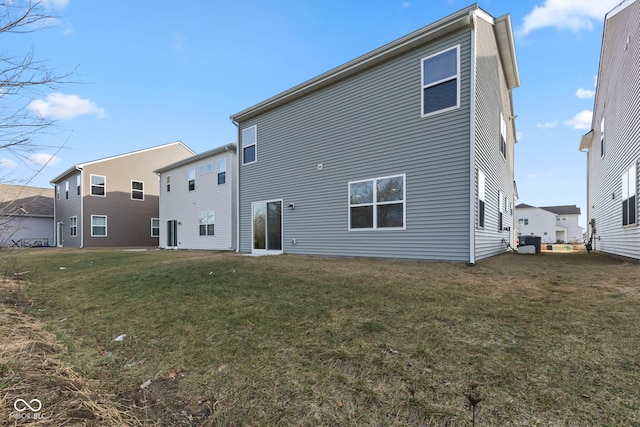 rear view of property with a lawn