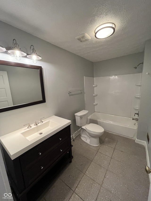 full bathroom with shower / tub combination, vanity, a textured ceiling, and toilet