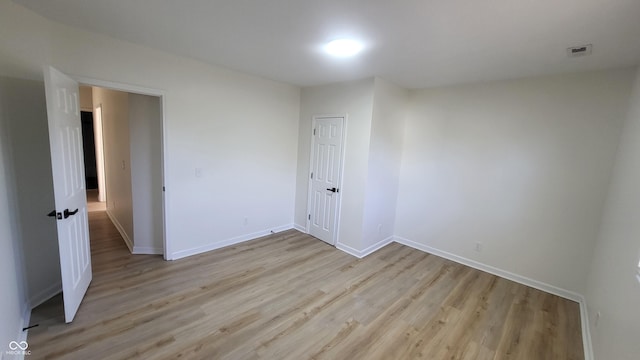 empty room with light hardwood / wood-style flooring