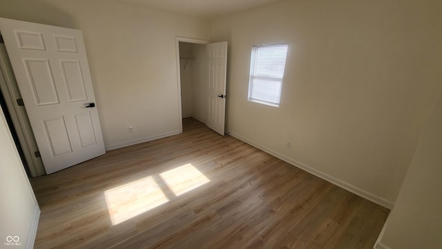 unfurnished bedroom featuring a closet and light hardwood / wood-style flooring