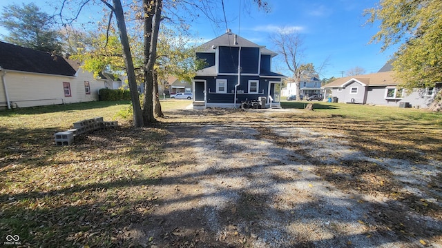 rear view of property with a lawn