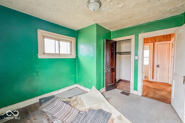 unfurnished bedroom featuring a closet and a textured ceiling