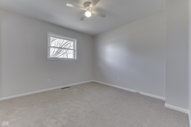 spare room featuring ceiling fan and light colored carpet