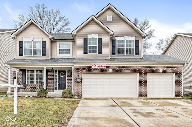 view of property featuring a garage and a front yard