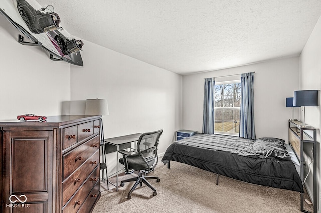 bedroom featuring light colored carpet and a textured ceiling