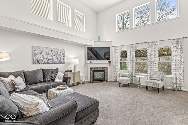 carpeted living room with a fireplace and plenty of natural light