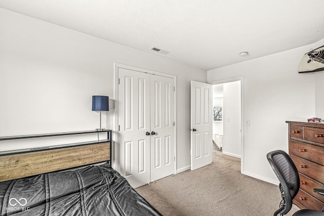 bedroom with light carpet and a closet