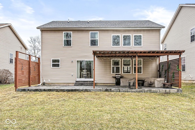 rear view of property featuring a yard and a patio