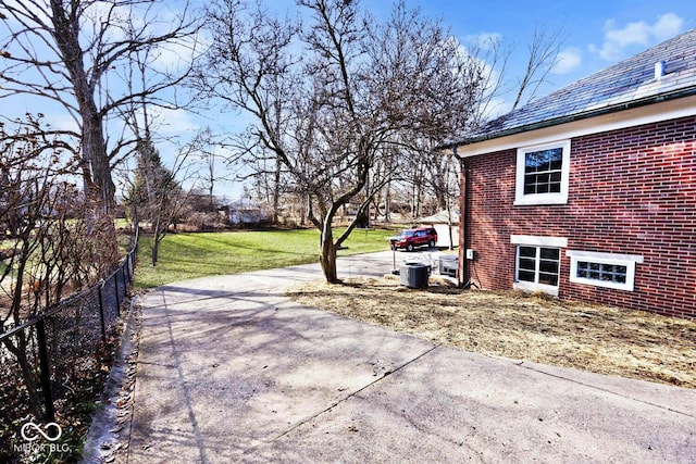 exterior space featuring a yard and central AC