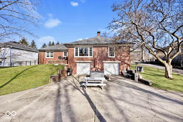 view of front of home with a garage and a front lawn