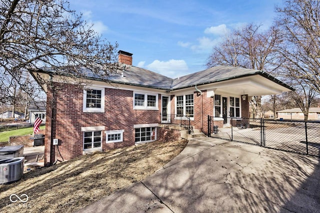 rear view of house featuring central AC