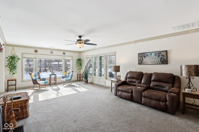 carpeted living room featuring crown molding, french doors, and ceiling fan