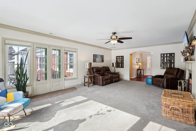 carpeted living room featuring crown molding and ceiling fan