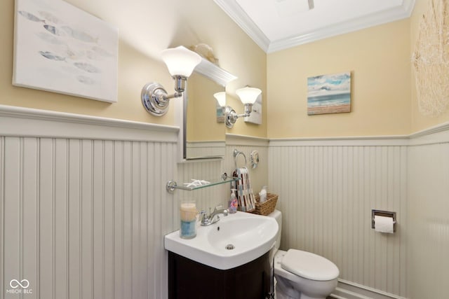 bathroom featuring vanity, ornamental molding, and toilet