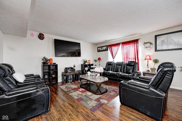 living room featuring dark wood-type flooring and a textured ceiling