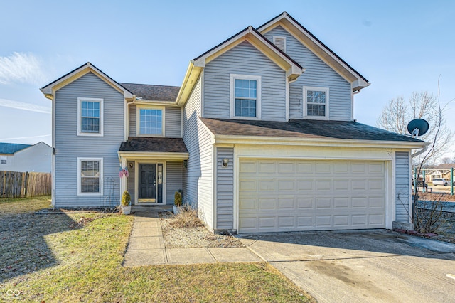 view of front of property featuring a garage and a front lawn