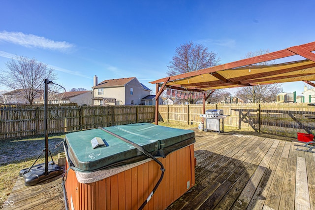 wooden terrace featuring grilling area, a hot tub, and a pergola