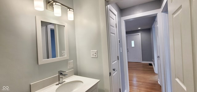 bathroom with hardwood / wood-style flooring and vanity