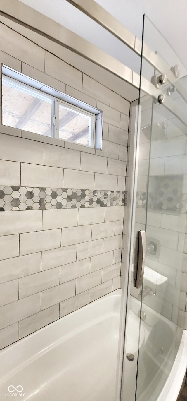 bathroom featuring shower / bath combination with glass door