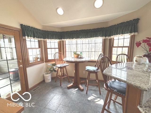 dining space with vaulted ceiling