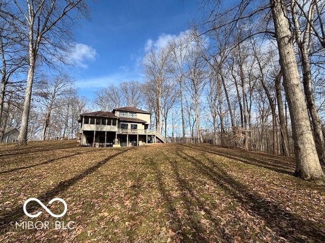 view of front facade featuring a deck and a front lawn