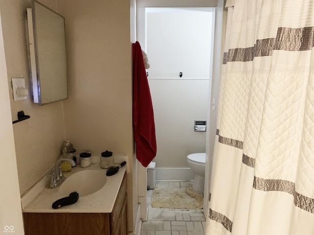 bathroom featuring vanity and toilet