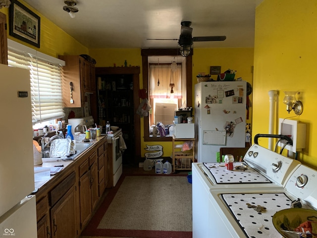 kitchen with washing machine and dryer, ceiling fan, and white appliances