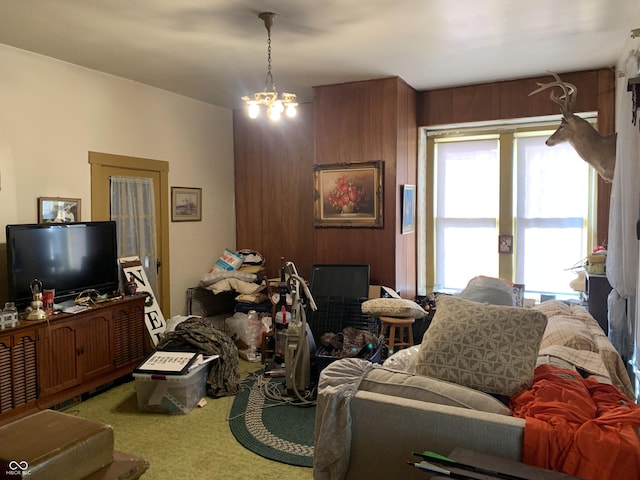 carpeted living room featuring a chandelier