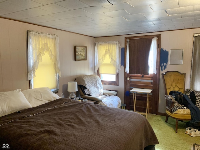 bedroom with ornamental molding and carpet