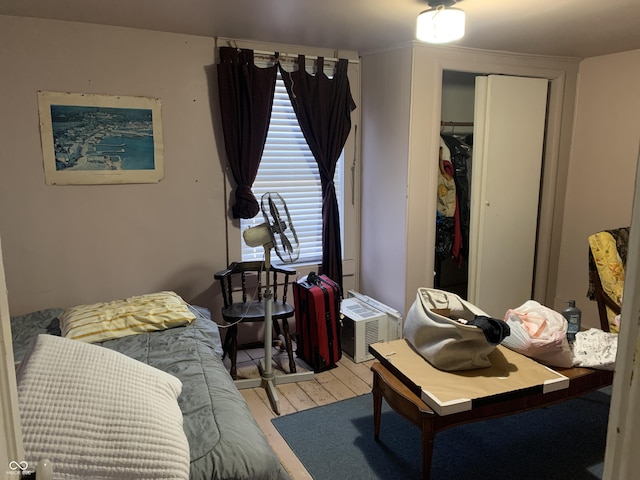 bedroom with wood-type flooring and a closet