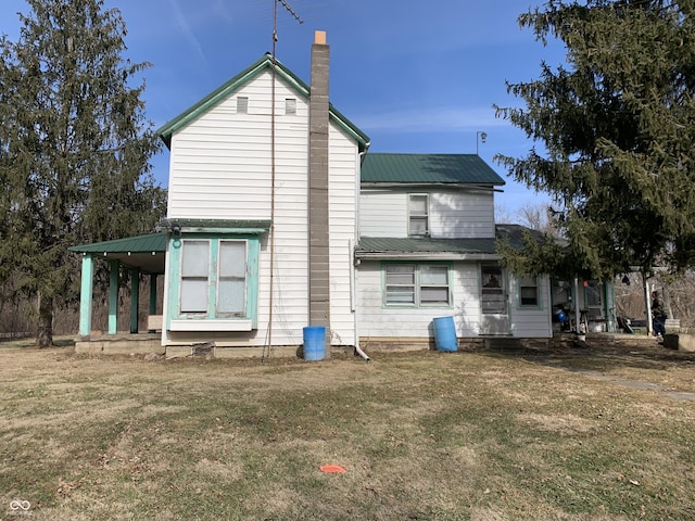 back of property featuring a lawn