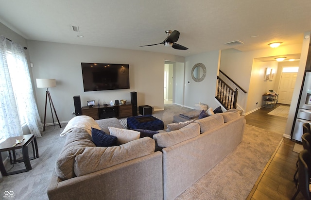 living room featuring hardwood / wood-style floors and ceiling fan