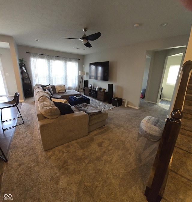 living room featuring carpet floors and ceiling fan