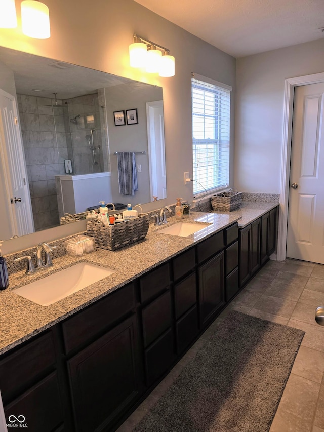 bathroom featuring vanity and tiled shower