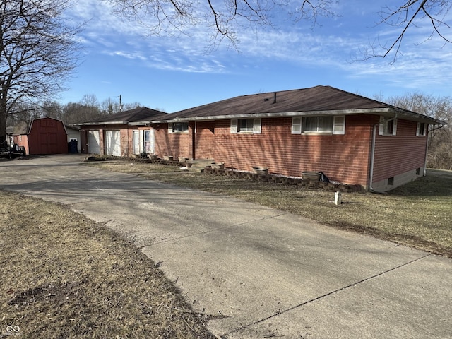 view of property exterior with a storage shed and a garage