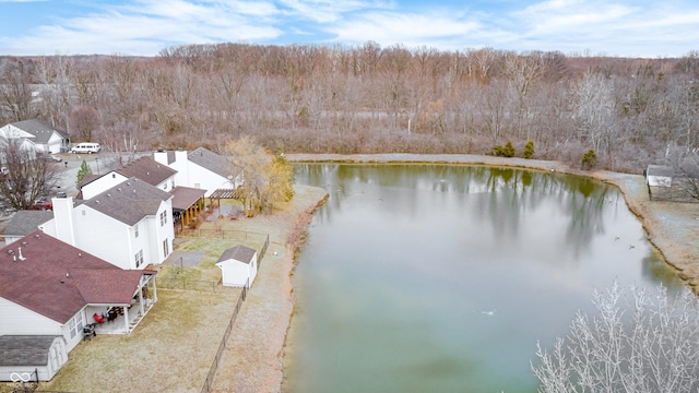 drone / aerial view with a water view and a view of trees