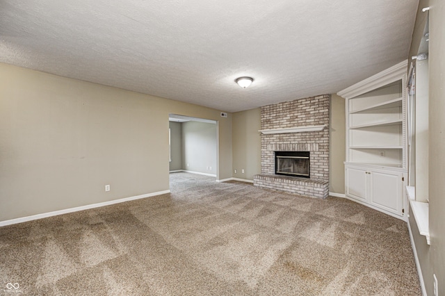 unfurnished living room featuring carpet, a fireplace, a textured ceiling, and baseboards