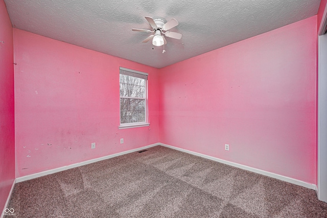 unfurnished room with carpet, visible vents, a ceiling fan, a textured ceiling, and baseboards