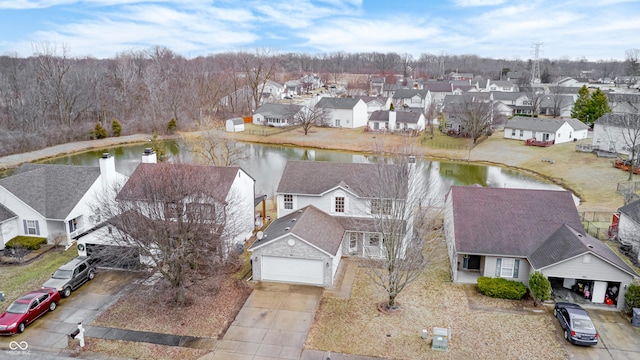 birds eye view of property featuring a water view and a residential view