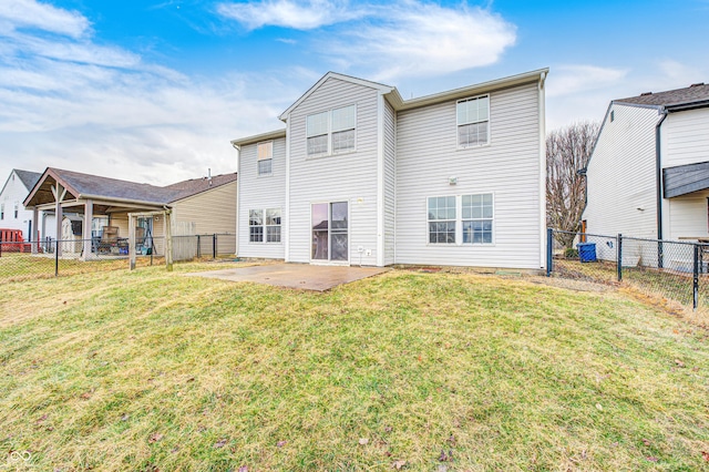 back of house featuring a lawn, a patio area, and a fenced backyard