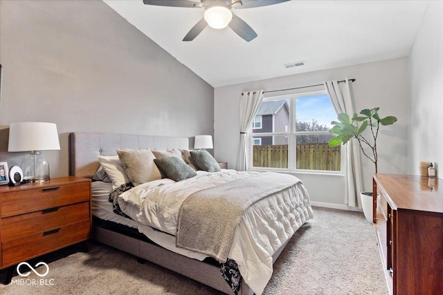 bedroom with vaulted ceiling, light colored carpet, and ceiling fan