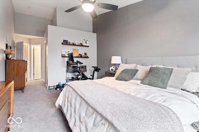 carpeted bedroom with ceiling fan and a high ceiling