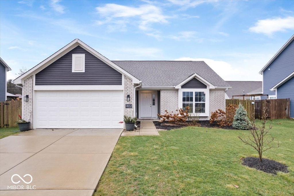 single story home with a garage and a front lawn