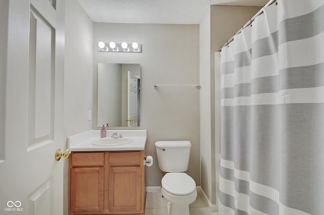 bathroom featuring tile patterned flooring, vanity, a textured ceiling, and toilet